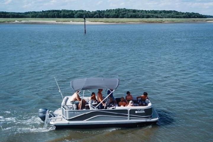 a group of people in a small boat in a body of water