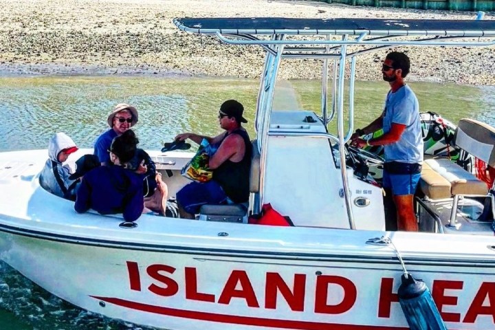 a group of people in a small boat in a body of water