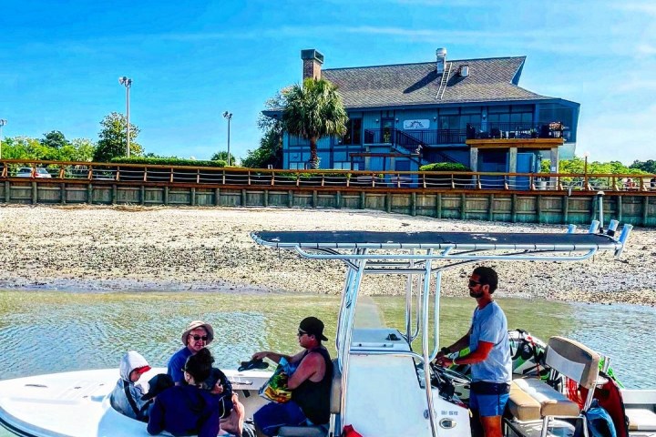 a group of people riding on the back of a boat