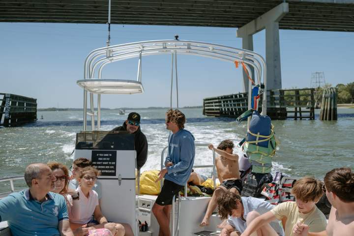 a group of people sitting at a dock