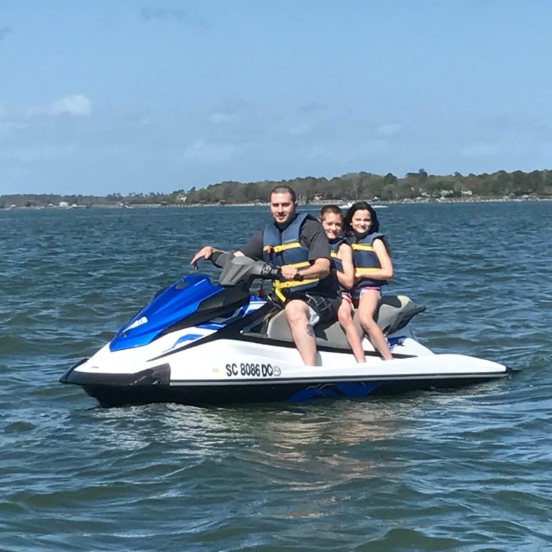 A family of three on a jet ski