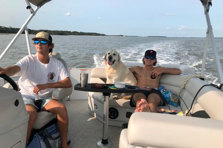 a couple of people that are sitting on a boat in the water