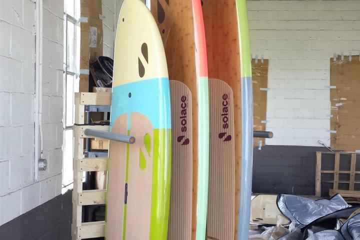 Three paddle boards in storage