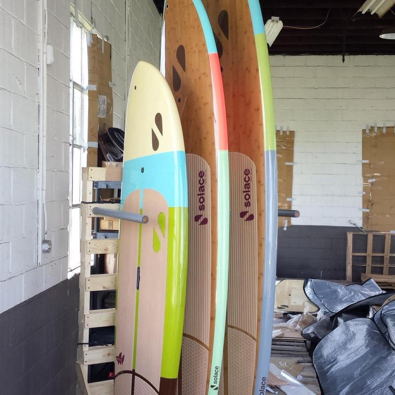 Three paddle boards in storage
