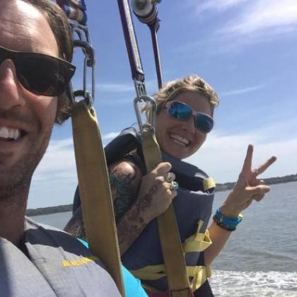 Two people in parasail harnesses