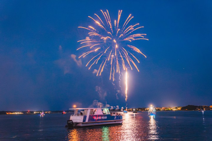 fireworks in the sky over a body of water