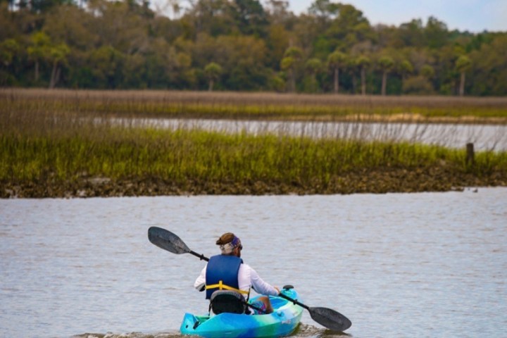 a man rowing a boat in a body of water