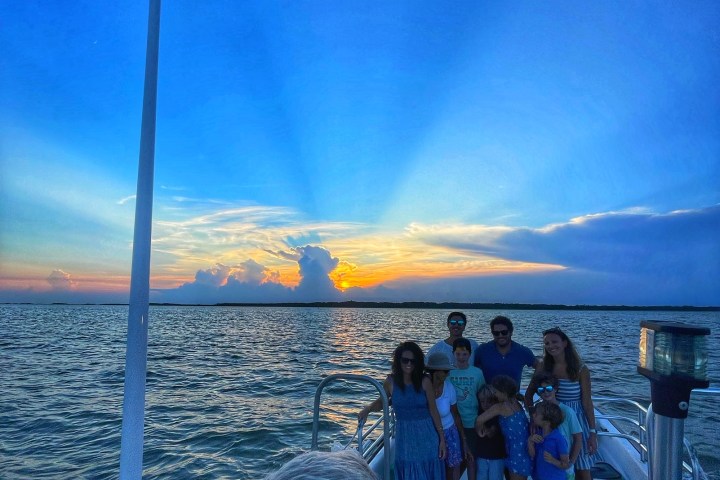 a group of people standing in front of a body of water