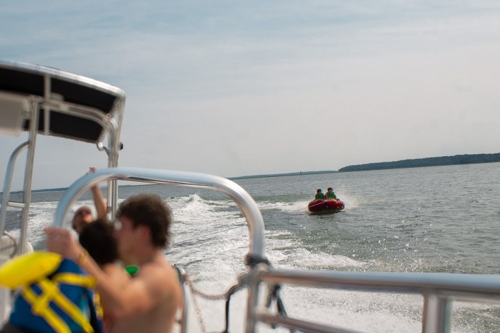 a person driving a boat on a body of water