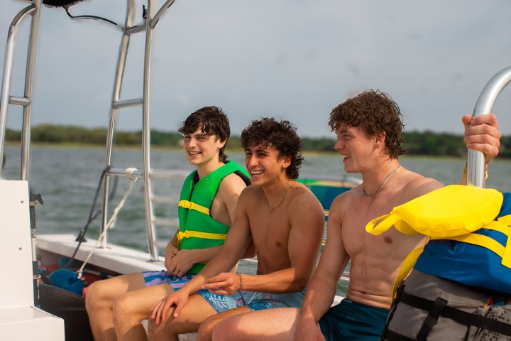 a young boy sitting on a boat