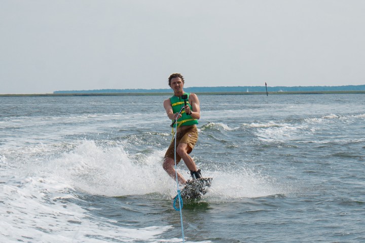 a person riding a surf board on a body of water