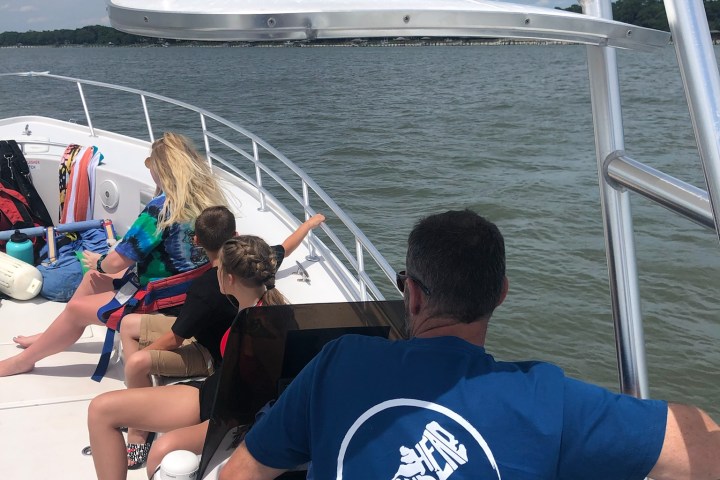 a group of people standing in front of a body of water