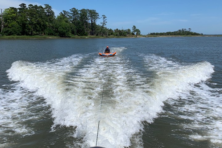 a man driving a boat in a body of water