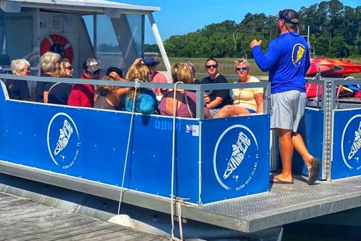 a group of people riding on the back of a boat