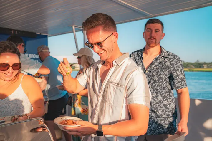 a group of people standing around a table